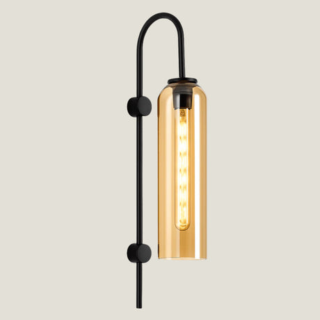 Ampule wall lamp from Love Hohm with a glass shade and black metal arm on a beige background