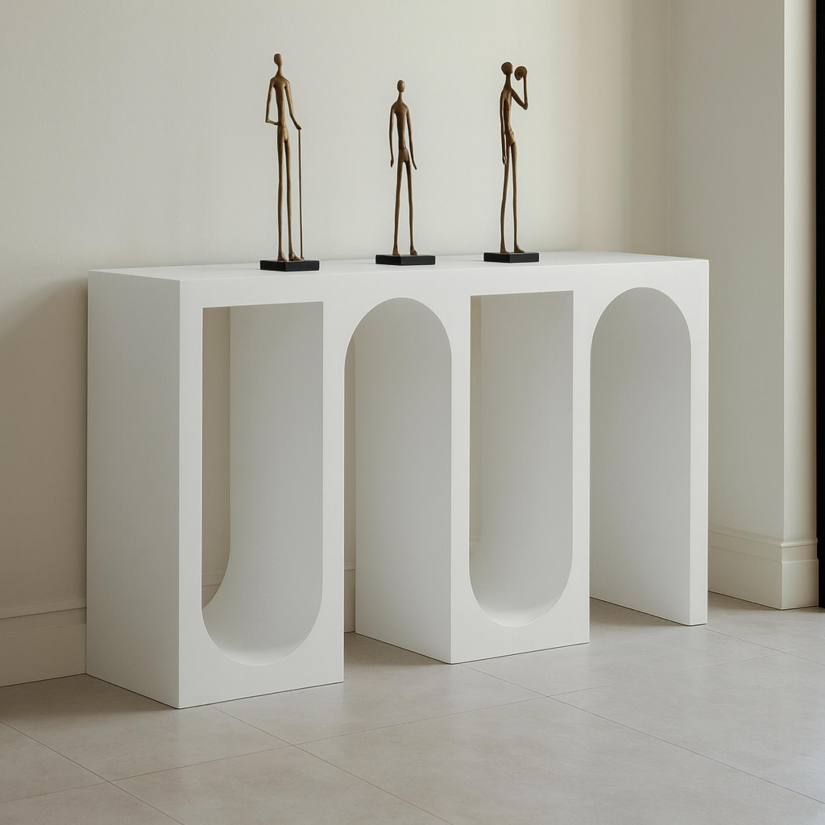 Archwell console table from Love Hohm with three bronze sculptures on a neutral background
