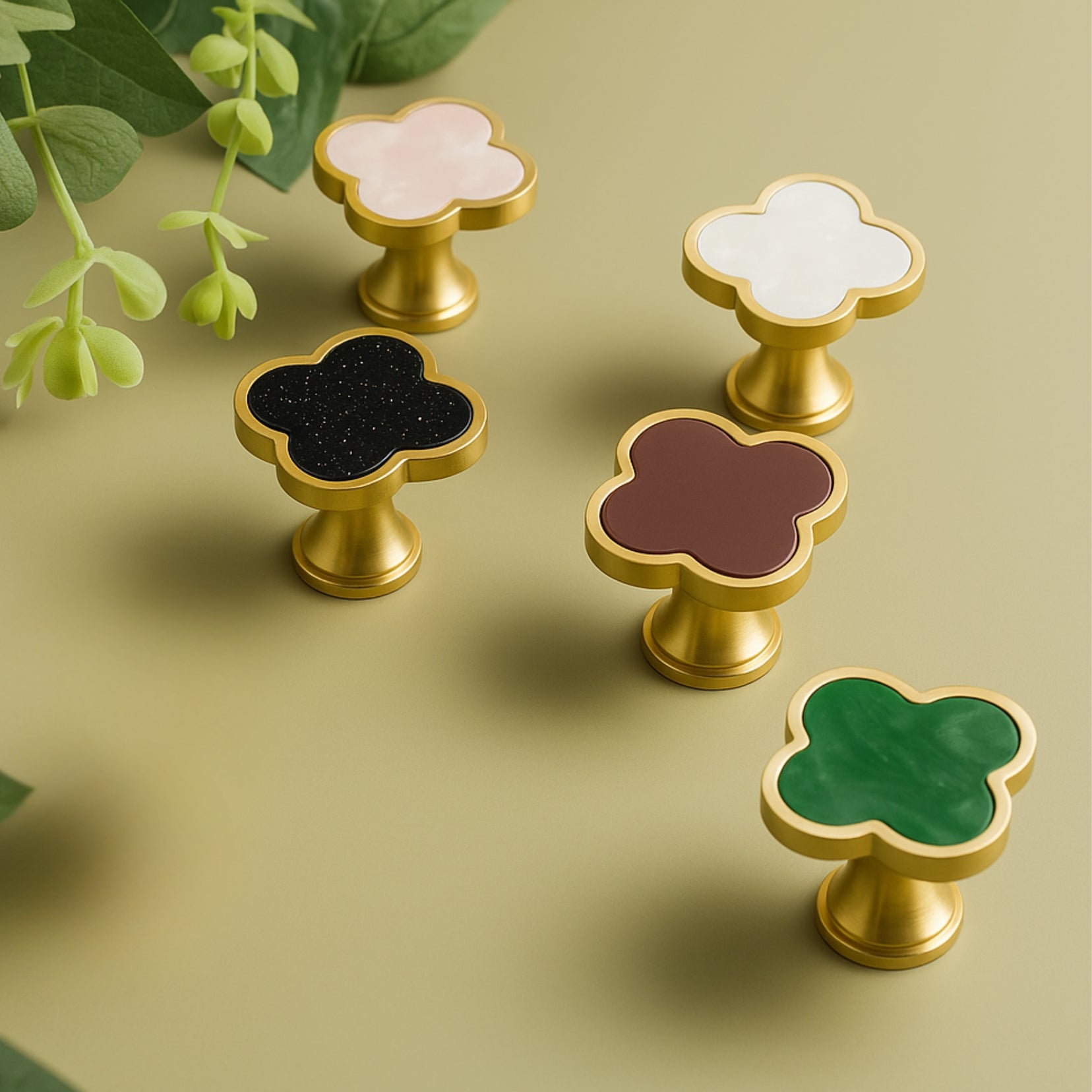 Charmant knobs by Love Hohm with gold borders on a green background