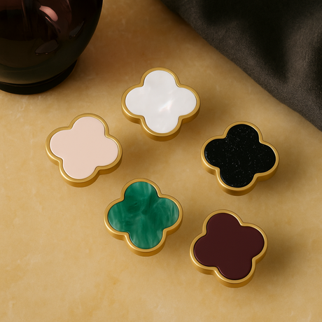 Charmant knob handles from Love Hohm in different colors on a beige surface.