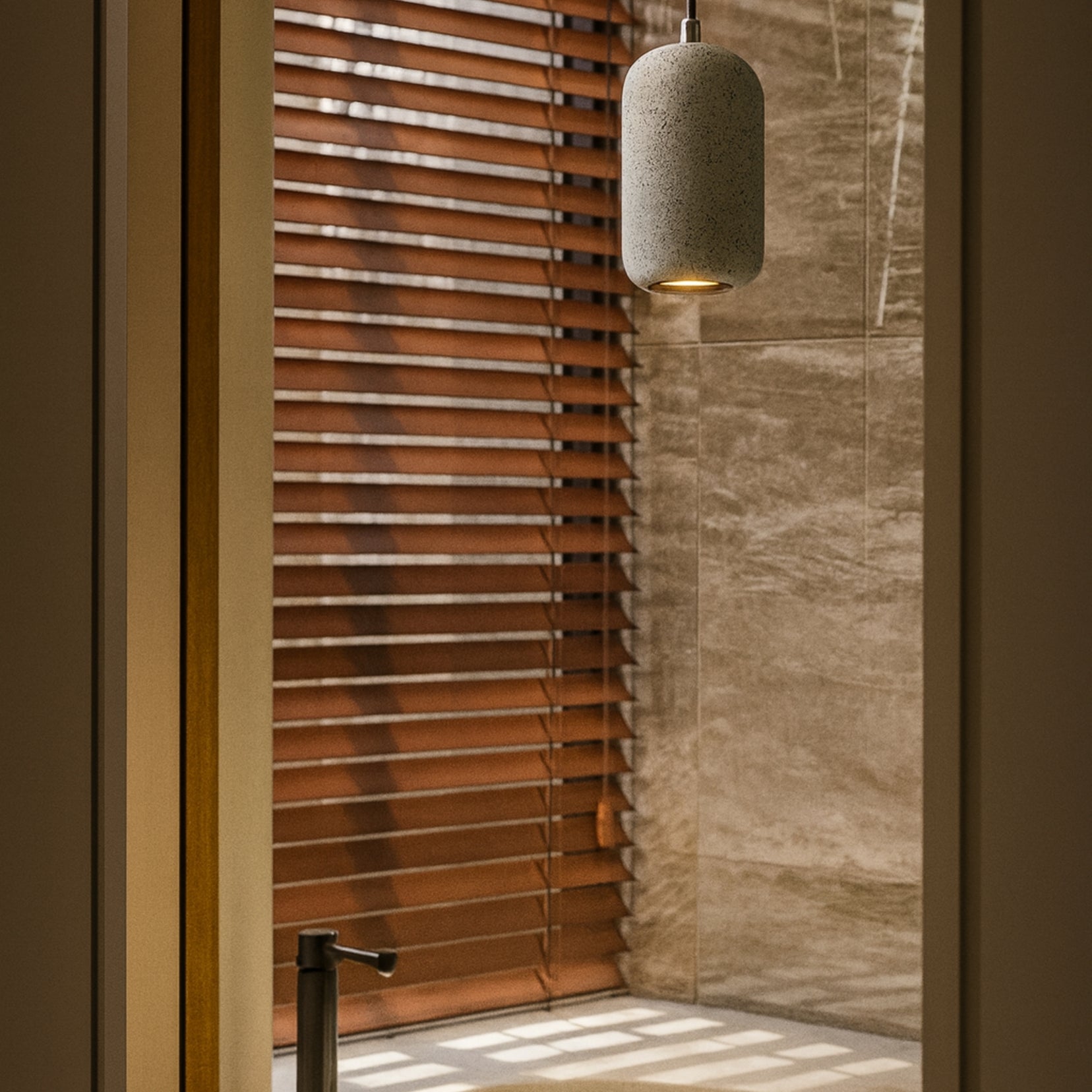 Shower area with wooden blinds and a hanging light fixture.