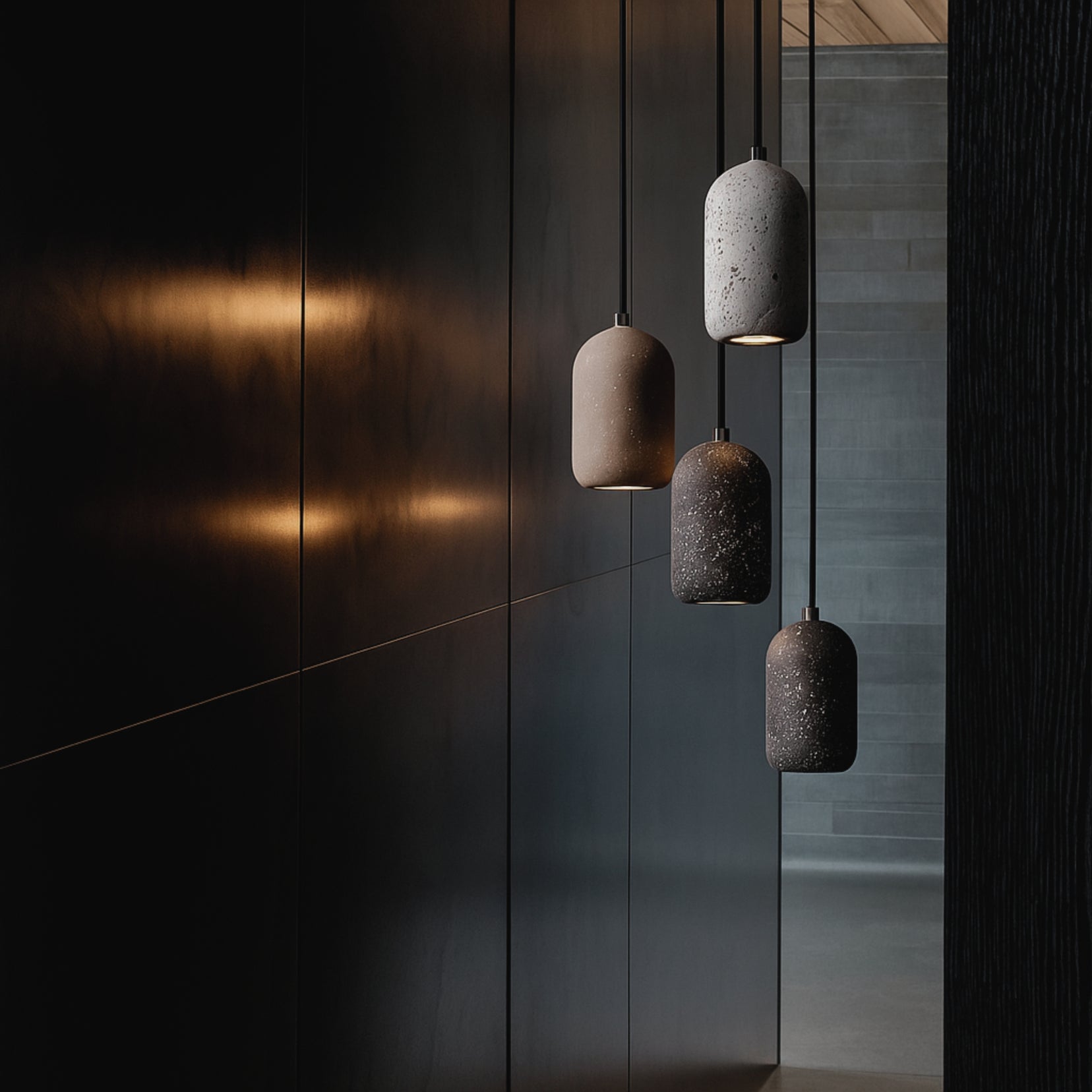 Four hanging ceramic lamps against a dark wall