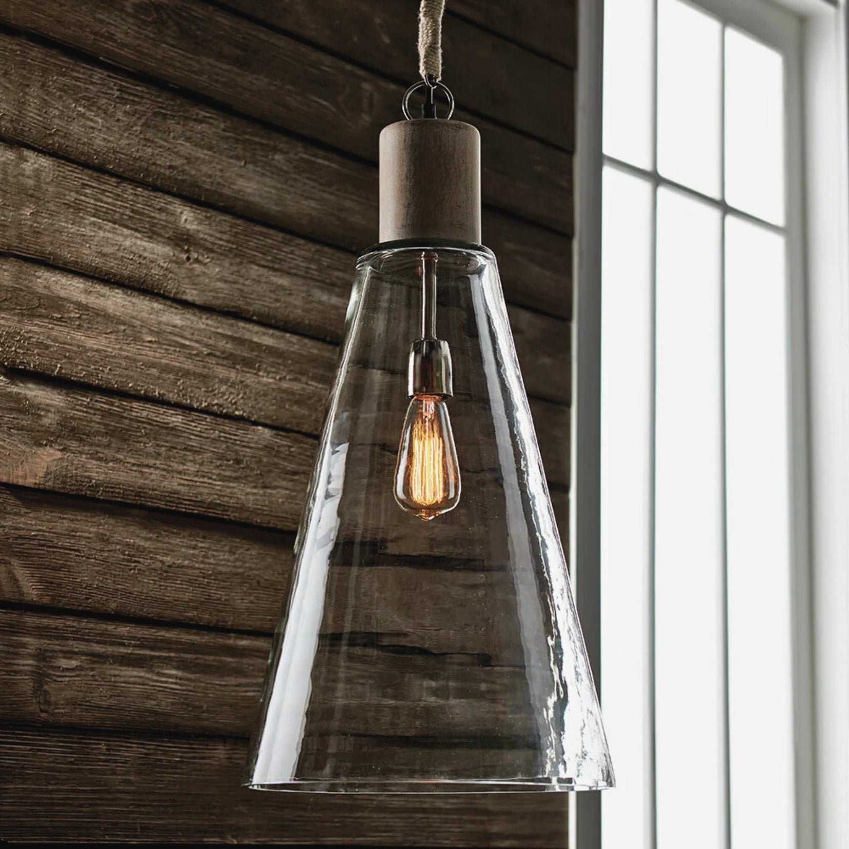 Clerestory glass pendant light from Love Hohm with clear glass shade and wooden ceiling