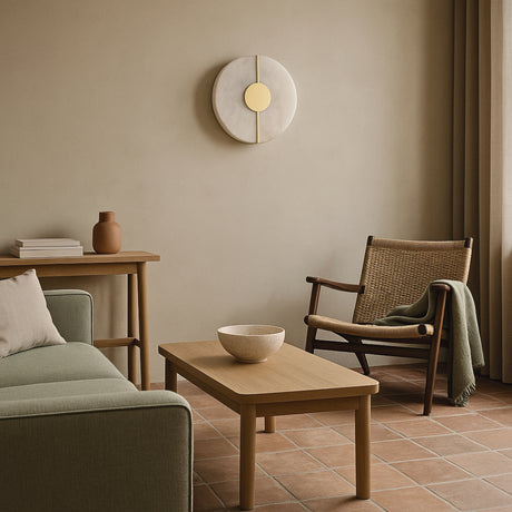 Modern living room with a sofa, coffee table, armchair, and a Corestone alabaster wall lamp from Love Hohm