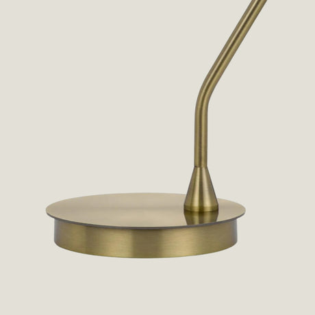 Formant brass floor lamp from Love Hohm with a minimalist design on a light beige background