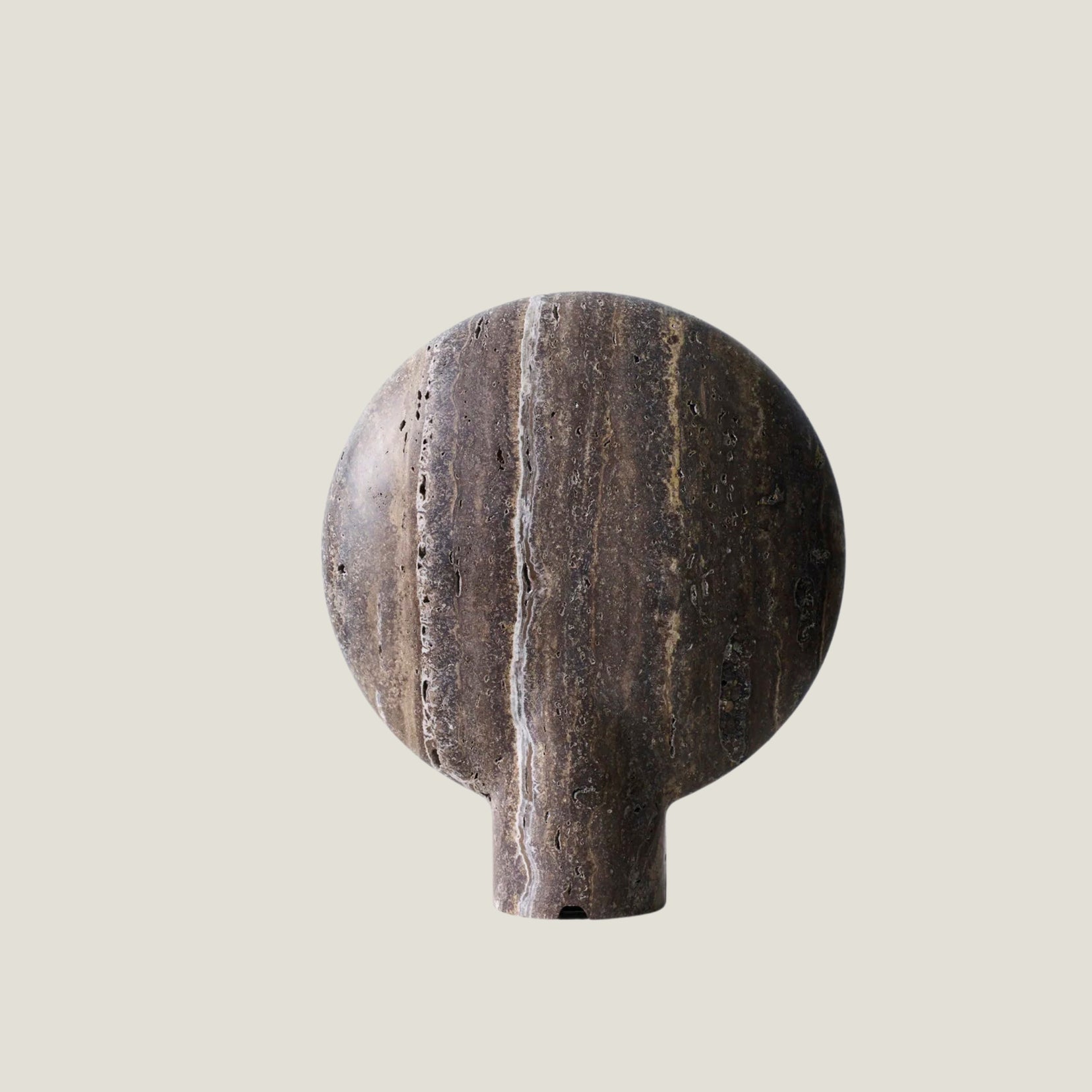 Fosse travertine table lamp on a light gray background