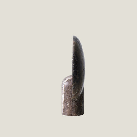 Fosse travertine table lamp on a light gray background