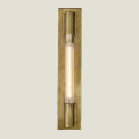Gilt brass wall lamp from Love Hohm on a beige background