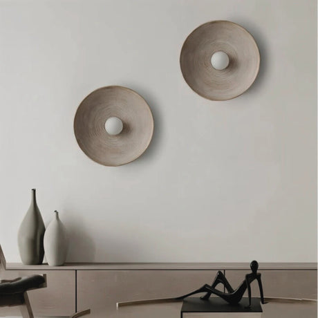 Two round Groove wall light from Love Hohm on a plain wall with minimal decor.