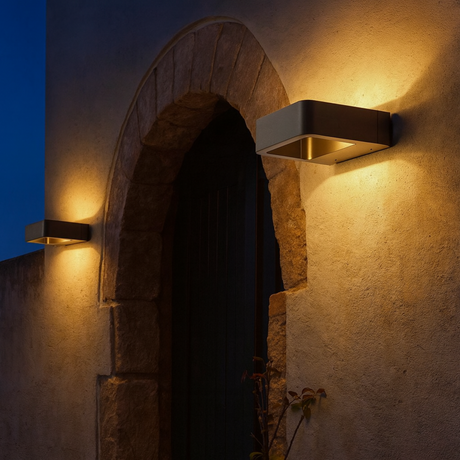 Ledger outdoor wall-mounted lights by Love Hohm on a stone wall at night