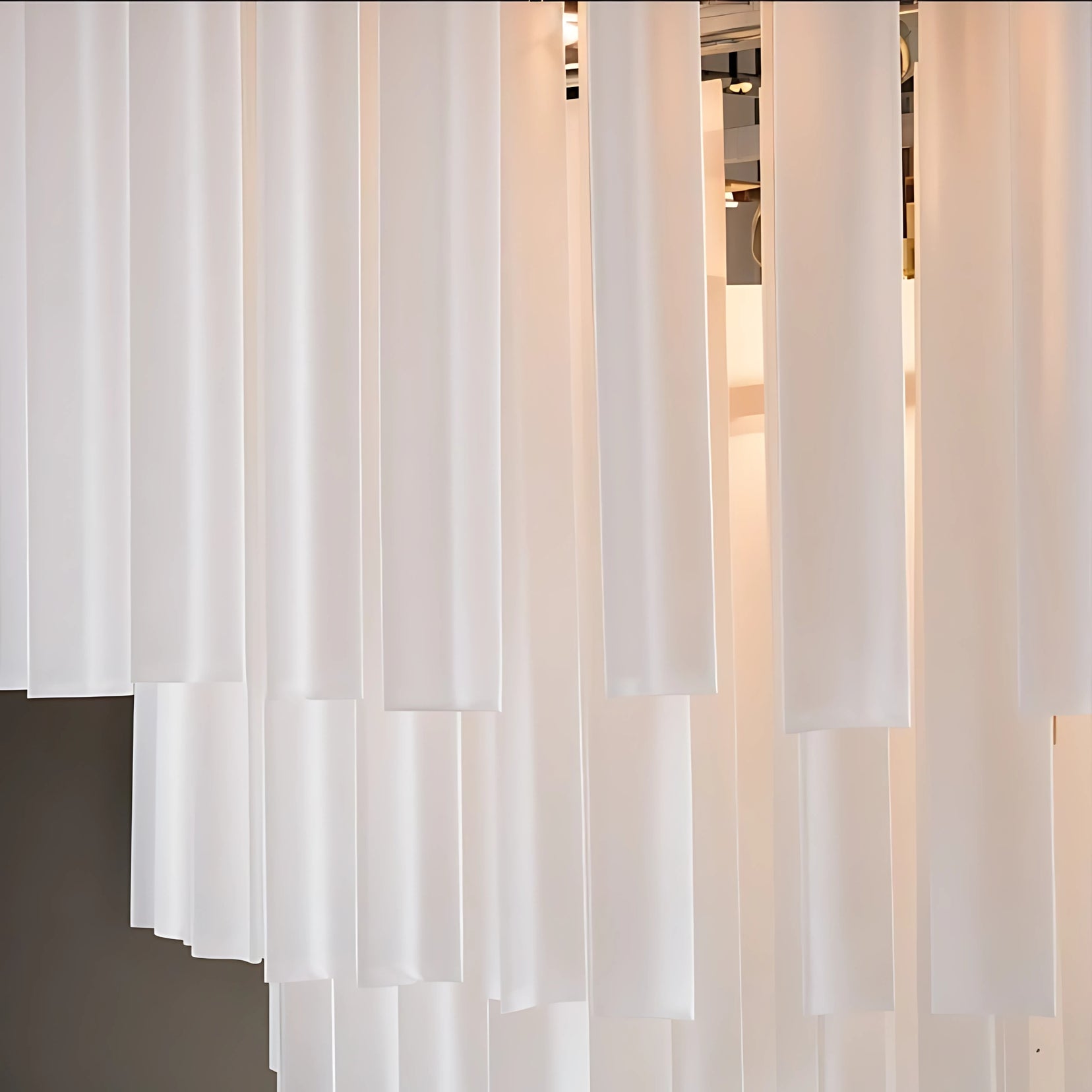 Monument Frosted Chandeliers from Love Hohm with a blurred indoor background