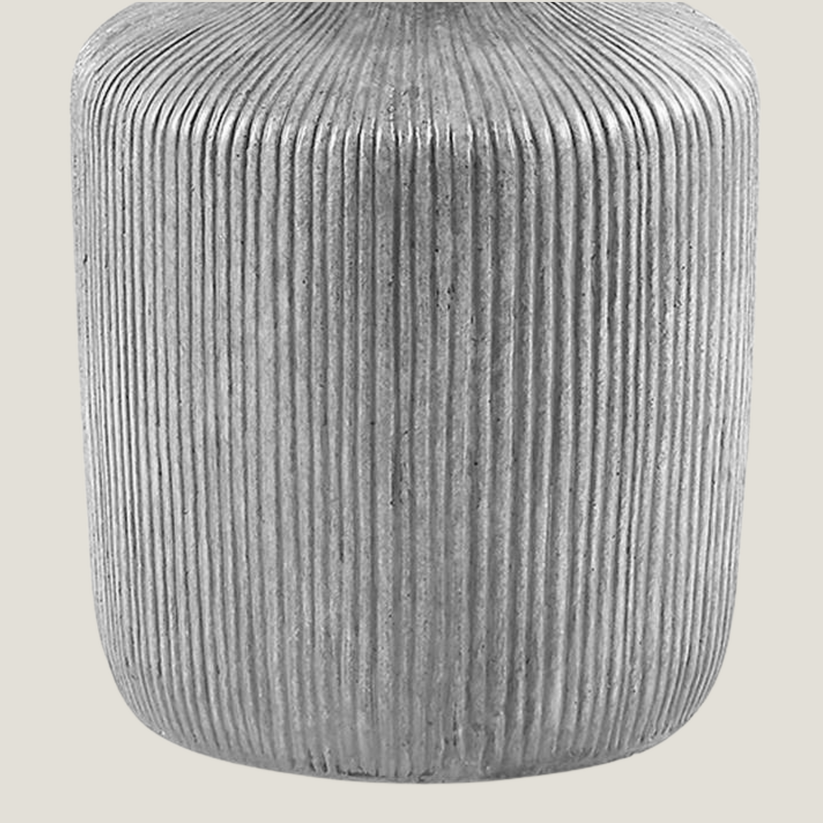 Gray ribbed cement side table from Love Hohm on a light beige background