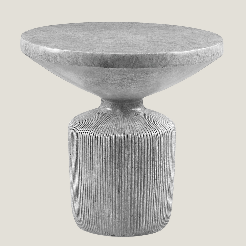 Oddurate gray cement side table from Love Hohm with ribbed cylindrical base on a light gray background