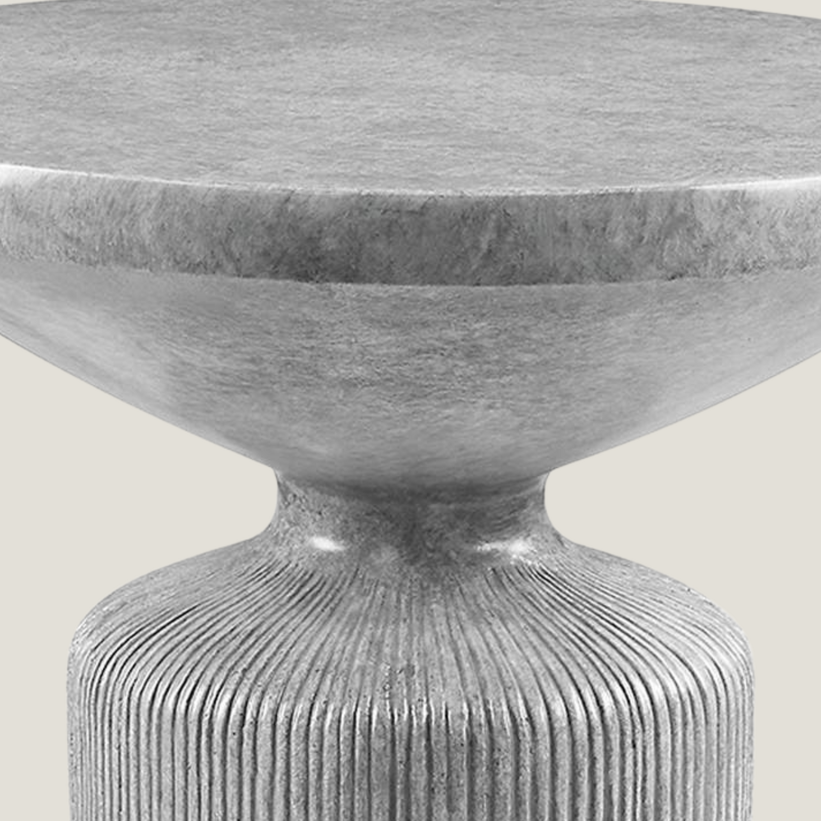 Obdurate gray cement side table from Love Hohm with a textured base on a light background