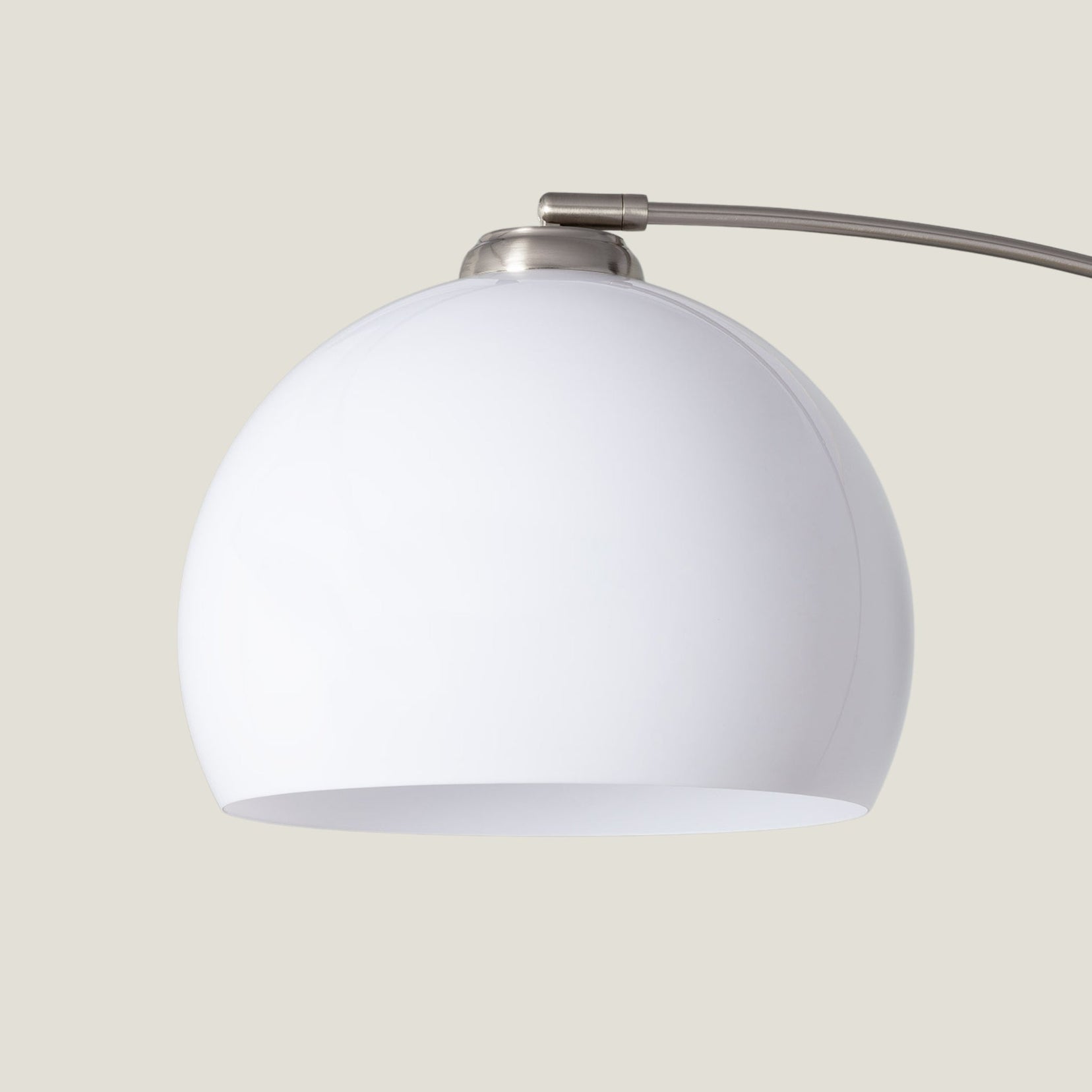 Overture arc floor lamp from Love Hohm on a beige background