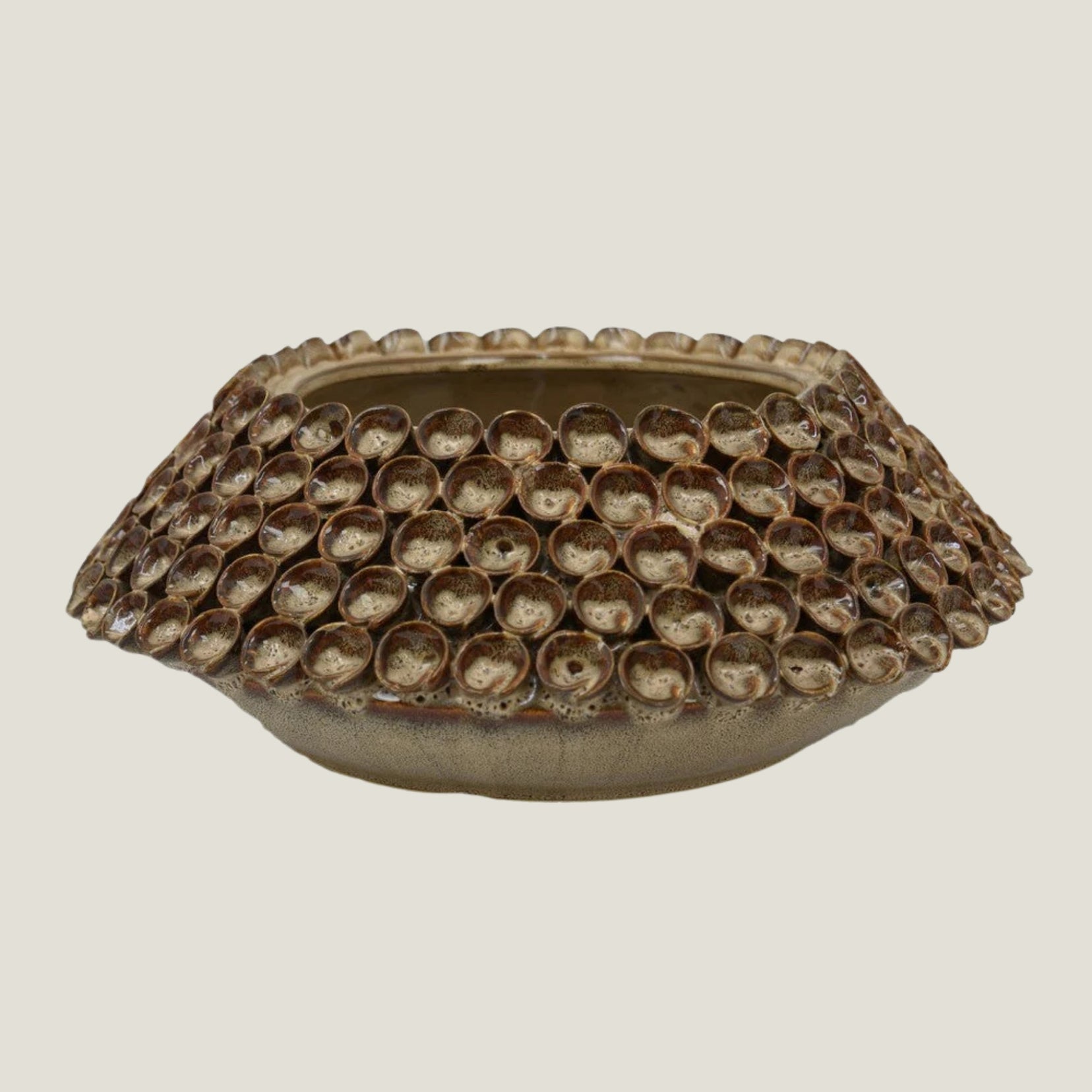 Thatch decorative ceramic bowl from Love Hohm with textured surface on a light gray background