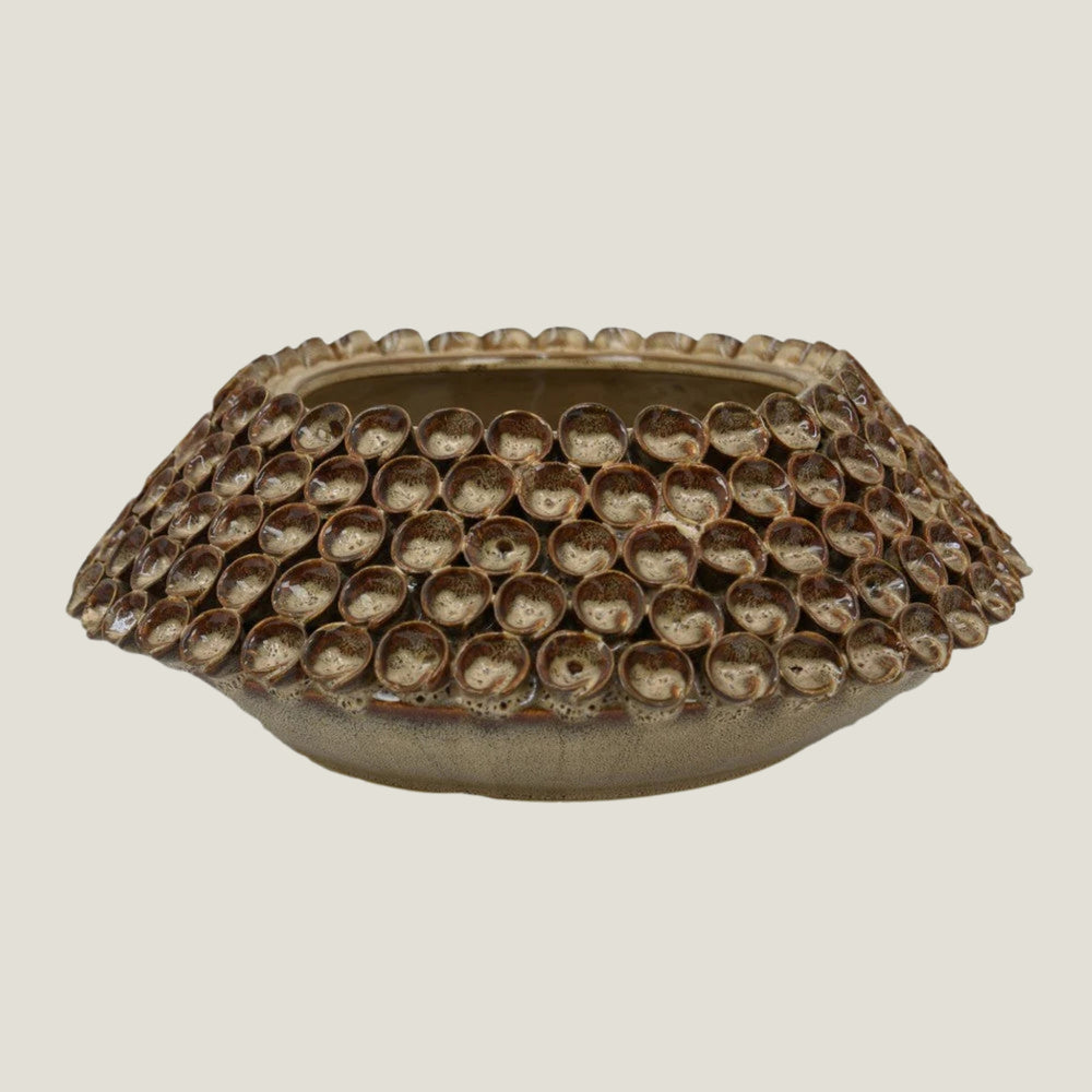 Thatch decorative ceramic bowl from Love Hohm with textured surface on a light gray background
