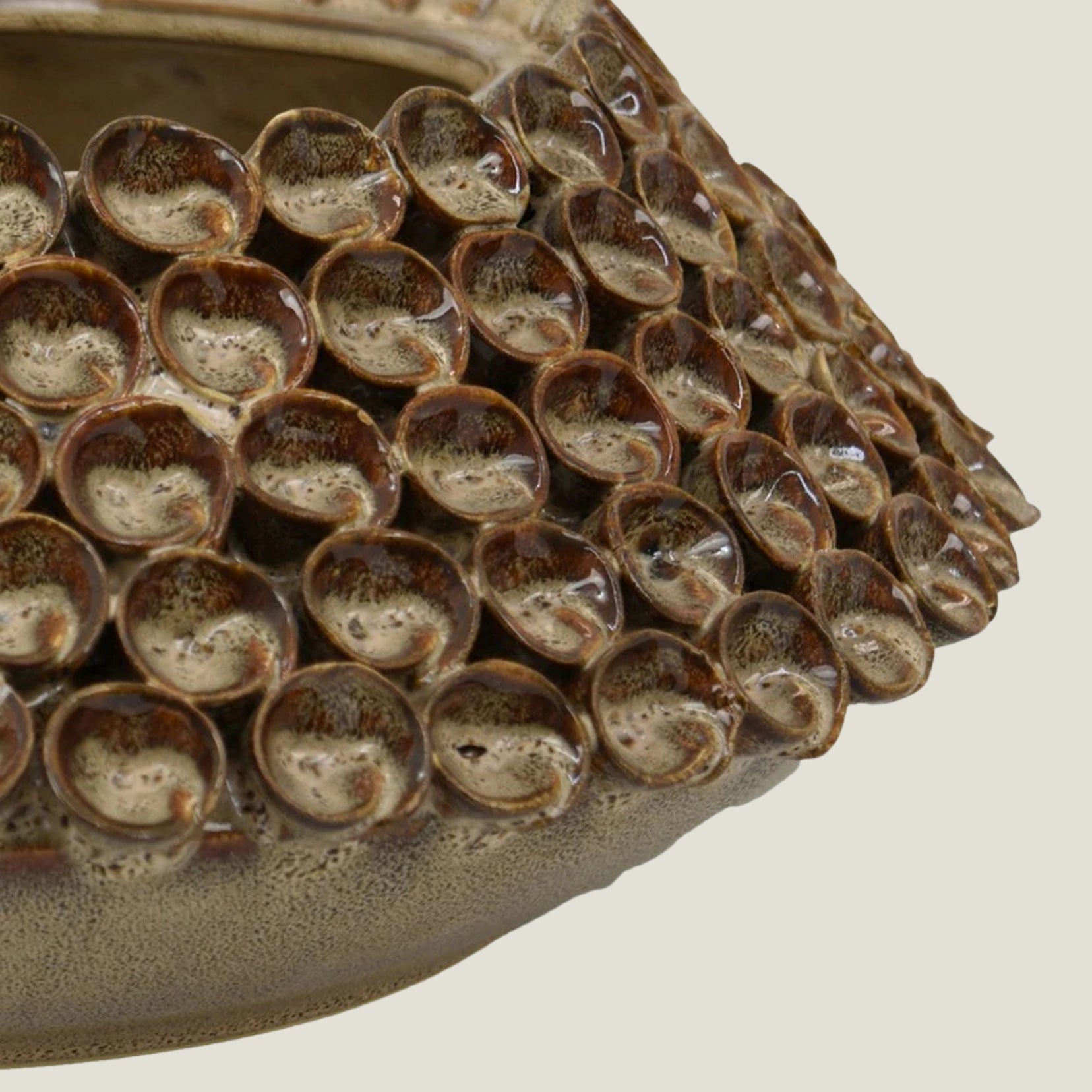 Thatch ceramic bowl from Love Hohm with textured surface and circular indentations on a neutral background