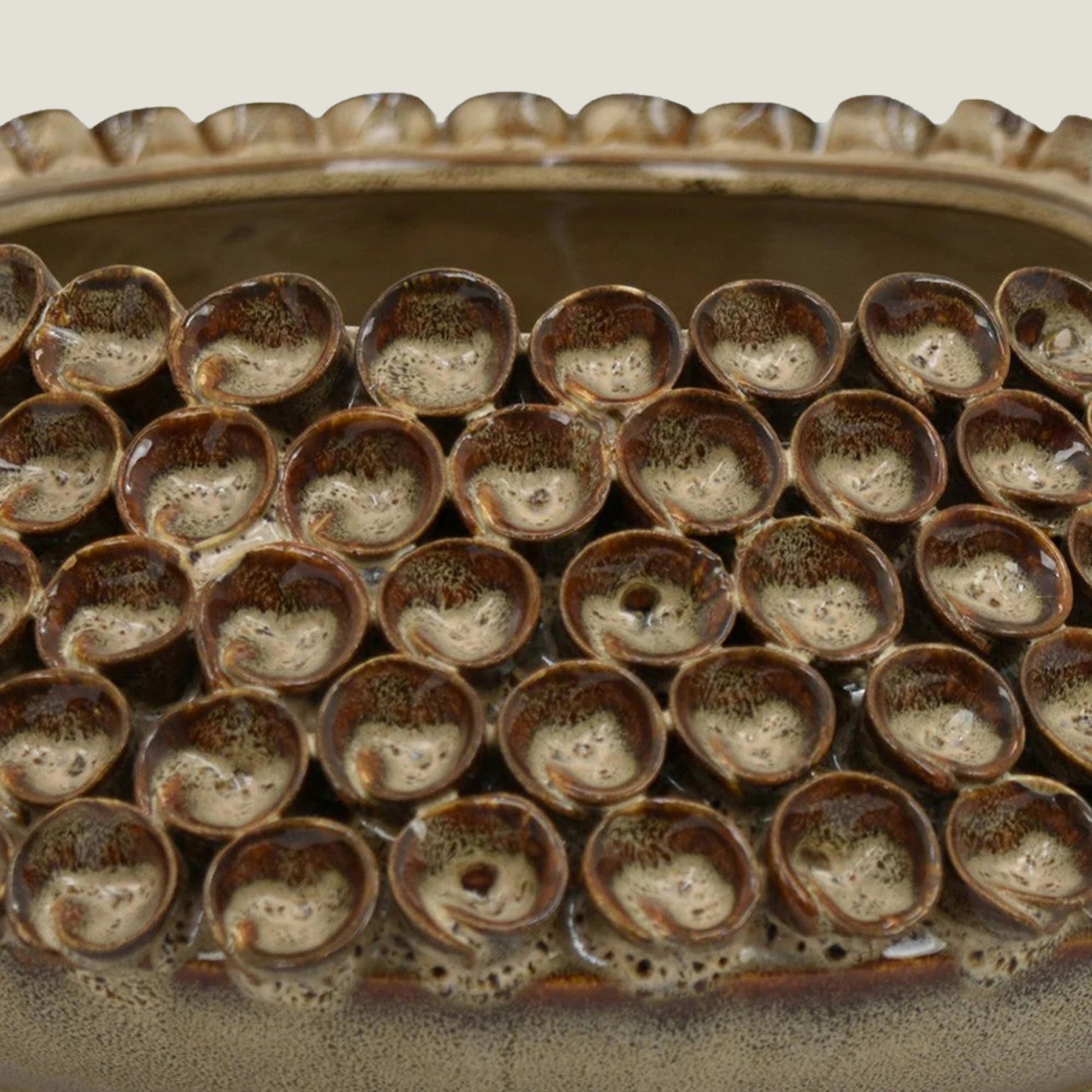 Close-up of a Thatch ceramic bowl from Love Hohm with small, rounded cups