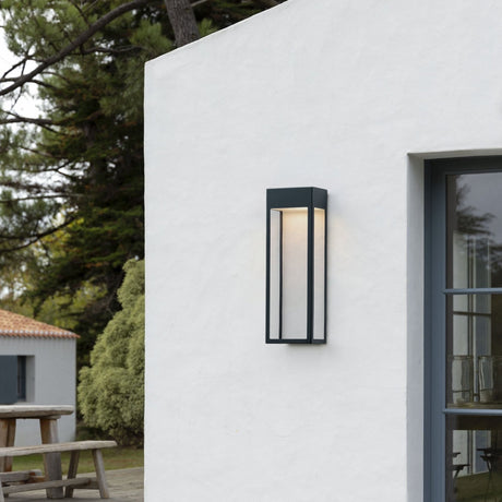 Threshold outdoor wall light from Love Hohm on a white building exterior with greenery in the background.