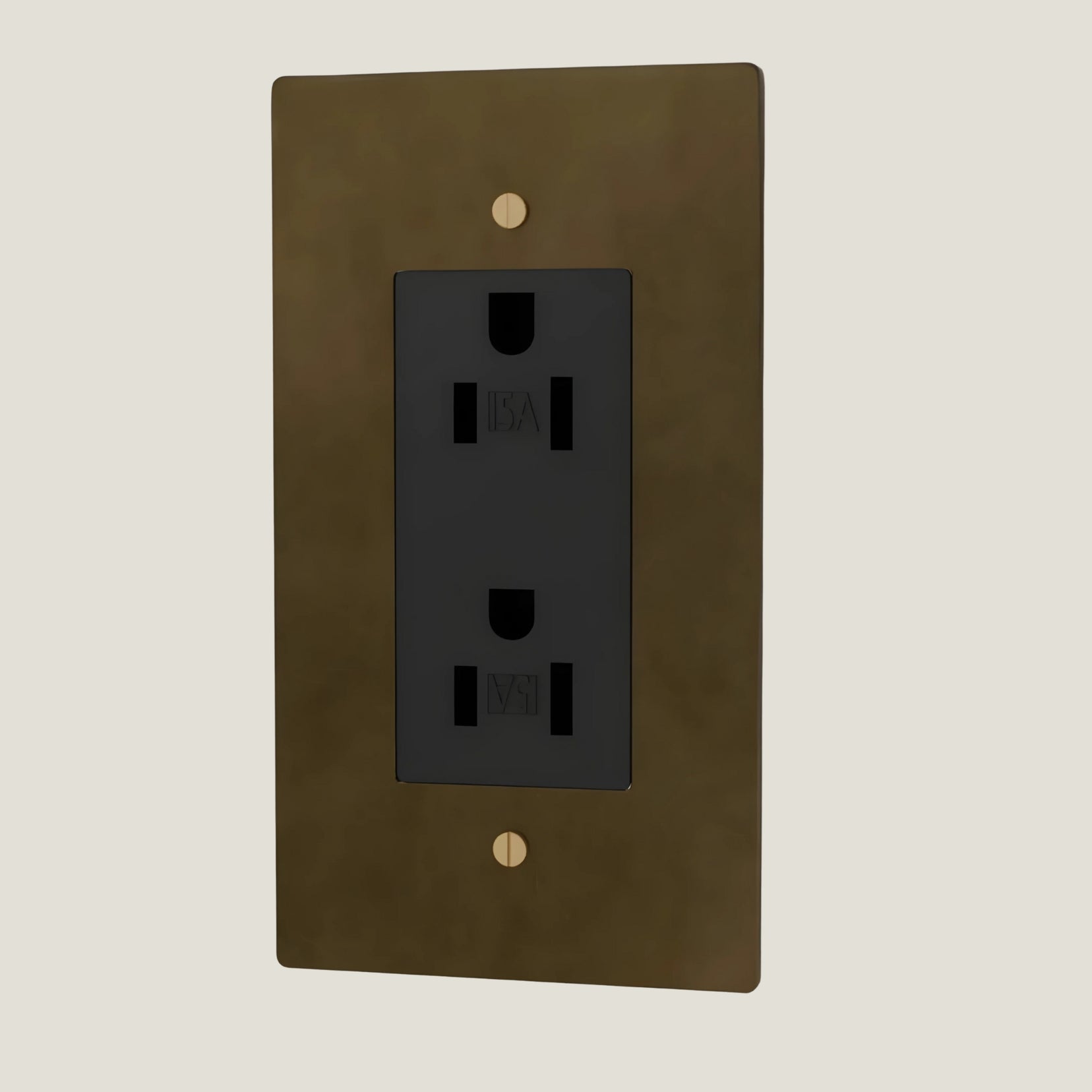 Verge outlet and brass wall plate from Love Hohm with black electrical outlet on a beige background