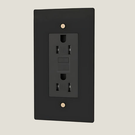 Verge brass wall outlet in black from Love Hohm on a beige background